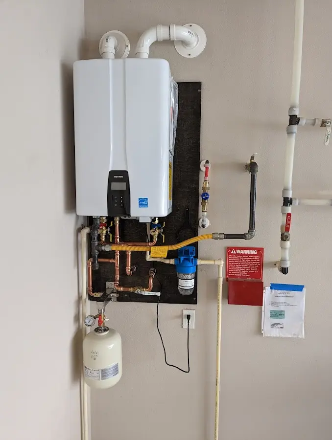 Professional plumber installing copper piping in a Lakeland Village home